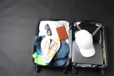 Masanın içinde farklı şeyler olan bavul. tatil