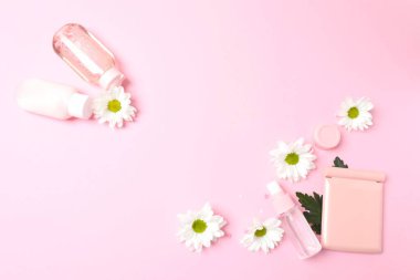 Kozmetik şişesi, çiçekler ve yapraklar. düz yat