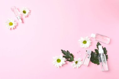 yaratıcı düz kompozisyon, çiçekler ve kozmetik. pembe arkaplan.