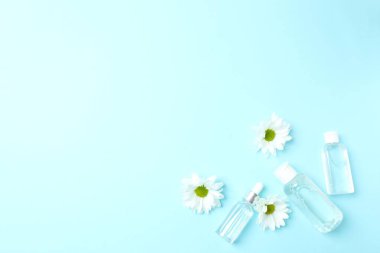 Mavi arkaplanda bir şişe papatya çayı ve nane şekeri..