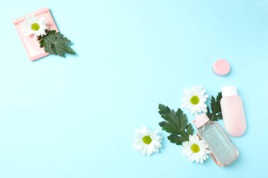 Pembe arka planda papatya çiçekli kozmetik ürünleri