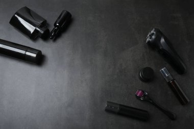 Koyu arkaplanda aksesuarları olan kozmetik ürünleri