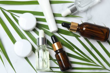 mermer zemin üzerinde serum şişeleri ve yüz yağı ile düz konum