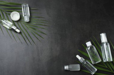 Siyah arka planda kozmetik şişeler ve palmiye yağı