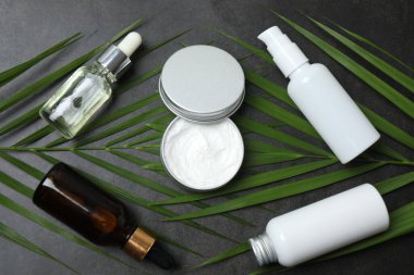 Beyaz arka planda yeşil yapraklı kozmetik ürünleri