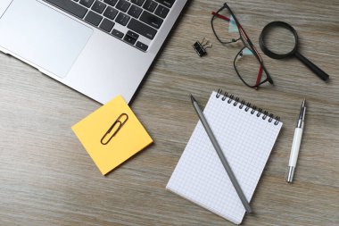 Tahta masadaki metin için kırtasiye malzemesi ve boşluk içeren düz konum