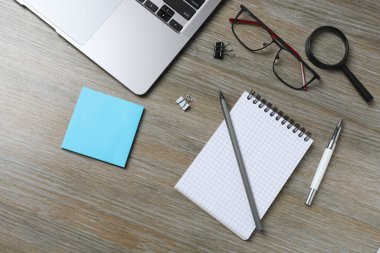 Tahta yüzeyde boş not defteri ve kalem, üst görünüm