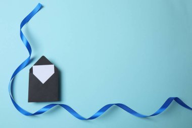 Beyaz arkaplanda beyaz ataçlı mavi bir ip.