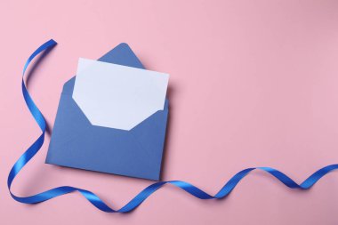 Mavi kurdeleli boş bir zarf ve mavi arka planda bir zarf. Metin için boşluk. mektup, zarf.