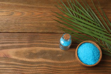 Beyaz zemin üzerinde mavi deniz tuzu, havlu ve ahşap tahta ile spa ve sağlık seti