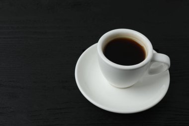 Siyah arka planda bir fincan kahve.