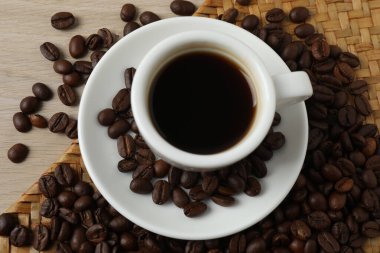 Beyaz ahşap masada kahve, tarçın ve fasulye.