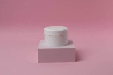 pembe bir arka plan üzerinde kozmetik krem.