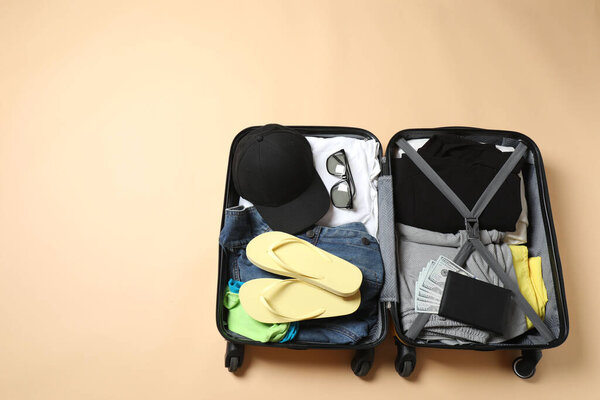 suitcase with different clothes on grey table