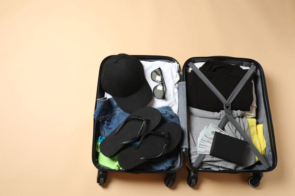 different travel stuff with bag and mask on wooden background, closeup view with space for text. vacation concept