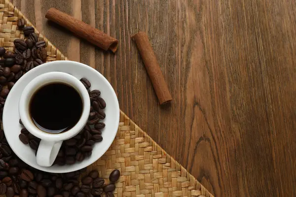Kahve çekirdekleri ve tarçınlı kahve fincanı.