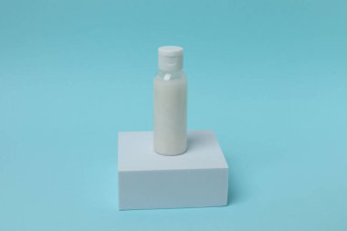 Mavi arka planda beyaz etiketli şişe