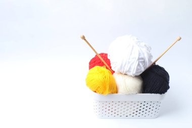 Beyaz arkaplanda örgü örmek için renkli iplik