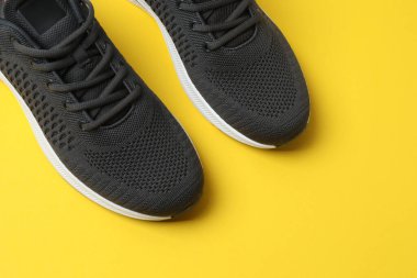 Sarı arka planda spor ayakkabılar, üst manzara