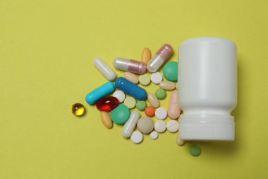 Tabletler sarı arka plana saçılmış.