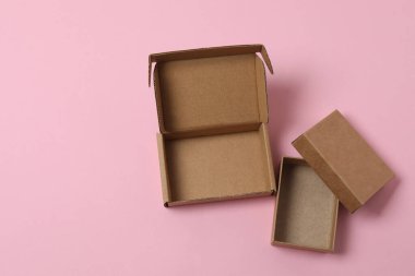 Pembe arka planda kapağı olan boş kağıt kutu, üst görünüm