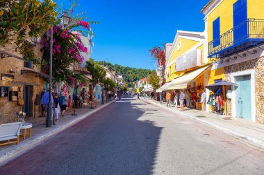 Katakolo, Yunanistan - 1 Kasım 2022: Güneşli bir sabah boyunca Katakolon Market 'te mağazaları olan sokak manzarası.
