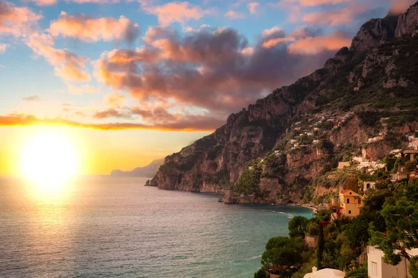 stock image Touristic Town, Positano, on Rocky Cliffs and Mountain Landscape by the Tyrrhenian Sea. Amalfi Coast, Italy. Sunset Sky Art Render.