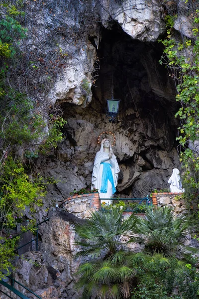 Statue of Mother Mary in a rocky cave. Saint. Capri Island, Italy.
