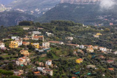 Картина, постер, плакат, фотообои "жилые дома на вершине горы у моря. рядом с туристическим городом сорренто, италия. облачный день. постер пейзаж", артикул 633054658