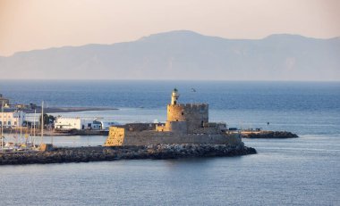 Lighthouse on the Mediterranean Sea in Rhodes, Greece. Sunny Evening.
