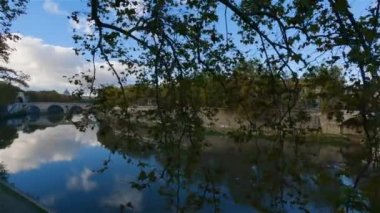 River Tiber and Bridge in a historic City, Rome, Italy. Sunny and Cloudy day. Cinematic Slow Motion