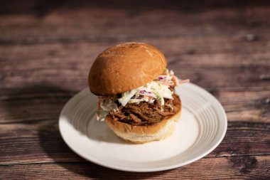 Pulled Pork Sandwish with Coleslaw on a plate.