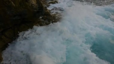 Rocky coast with waves on Mediterranean Sea. Italy, Europe. Nature Background. Sunset Sky. Slow Motion Cinematic