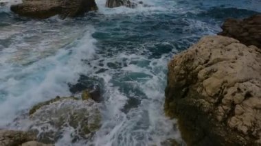 Rocky coast with waves on Mediterranean Sea. Italy, Europe. Nature Background. Sunset Sky. Slow Motion Cinematic