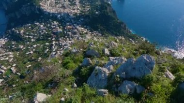 Touristic Town on Capri Island in Bay of Naples, Italy. Sunny Blue Sky. Nature Background. View from top of Mountain. Slow Motion Cinematic Pan