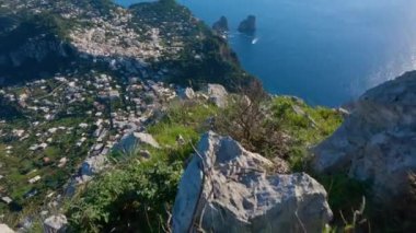 Touristic Town on Capri Island in Bay of Naples, Italy. Sunny Blue Sky. Nature Background. View from top of Mountain. Slow Motion Cinematic Pan