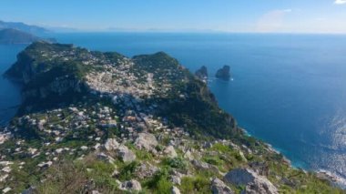 Touristic Town on Capri Island in Bay of Naples, Italy. Sunny Blue Sky. Nature Background. View from top of Mountain. Slow Motion Cinematic Pan