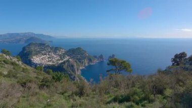 Touristic Town on Capri Island in Bay of Naples, Italy. Sunny Blue Sky. Nature Background. View from top of Mountain. Slow Motion Cinematic Pan