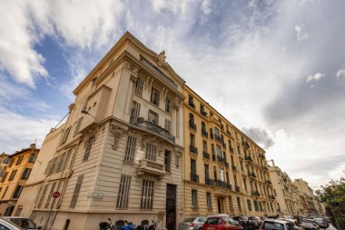 Nice, France - December 3, 2022: Old architectural buildings in the downtown city. Sunny Cloudy Sky.