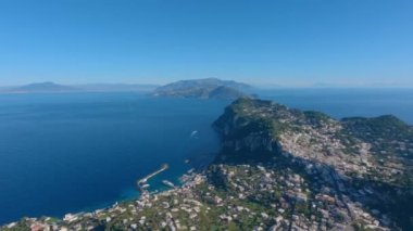 Touristic Town on Capri Island in Bay of Naples, Italy. Sunny Blue Sky. Nature Background. View from top of Mountain. Slow Motion Cinematic Pan