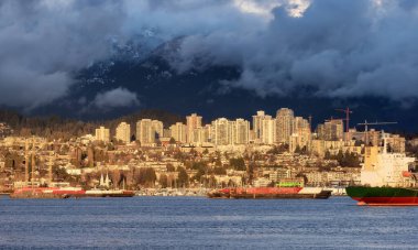 Residential Homes and Buildings in Modern City. Mountains in Background. North Vancouver, British Columbia, Canada.