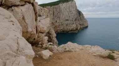 View of Rocky Coast with Cliffs on the Mediterranean Sea. Regional Natural Park of Porto Conte, Sardinia, Italy. Nature Background. Slow Motion Cinematic