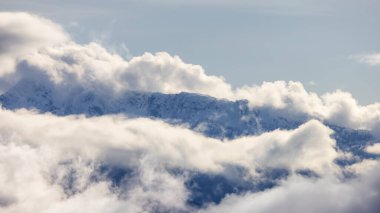 Tantalus Range covered in Snow and Clouds during Winter Season. Near Whistler and Squamish, British Columbia, Canada. Nature Background