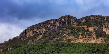 Rocky Mountain by the Sea Coast. Cloudy Sky. Sardinia, Italy. Nature Background