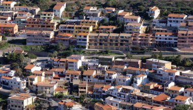 Town on the sea coast, Buggerru, Sardinia, Italy. Sunny Fall Season Day.