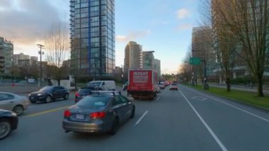 Vancouver, British Columbia, Canada - January 18, 2023: Driving in Urban Downtown City Streets during Winter Sunset. Traffic Jam towards the Lions Gate Bridge. Slow Motion