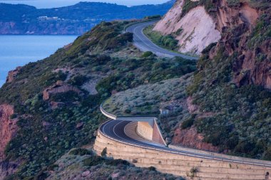 Scenic Highway on the Sea Coast during Sunny Fall Season Sunset. Sardinia, Italy. Adventure Travel