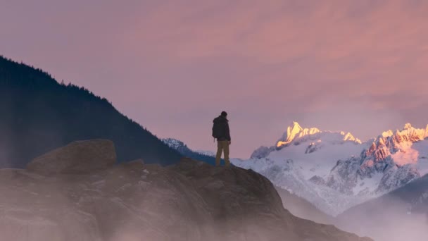 Adventurous Man Hiker Standing Top Icy Peak Rocky Mountains Background — Stock Video