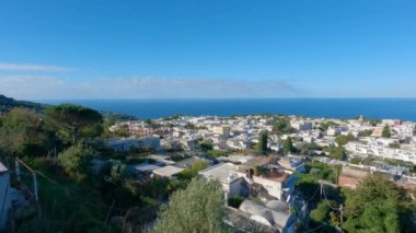 Touristic Town on Capri Island, Bay of Naples, Italy. Sunny Blue Sky. Nature Background. View from top of Mountain. Slow Motion Cinematic