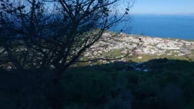Touristic Town on Capri Island, Bay of Naples, Italy. Sunny Blue Sky. Nature Background. View from top of Mountain. Slow Motion Cinematic